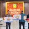 Kepala Distrik Mimika Barat Jauh (Batik Biru) saat menerima hadiah sebagai Juara 2 Kategori Inovasi Distrik dalam perlombaan Mimika Innovation Week 2025, Kamis (9/10/2025). (Foto: Istimewa) 
