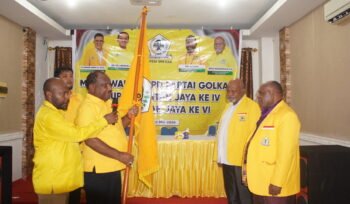 Ketua Harian DPD I Partai Golkar Papua Tengah, Willem Wandik saat menyerahkan bendera pataka kepada ketua terpilih. (Foto: Kristin Rejang/Sasagupapua.com.