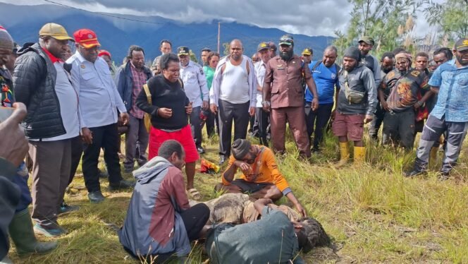 
Bupati Intan Jaya, Aner Maisini, Wakil Bupati Intan Jaya, Elias Igapa, Tim penanganan Konflik, bersama masyarakat saat mengevakuasi jenazah Okto Tigau di belakang Pos Habema. (Foto: Istimewa)