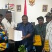 Wakil Ketua IV DPR Papua Tengah, John Gobai saat menyerahkan salinan Perdasi terkait pertambangan rakyat. (Foto: Ist)
